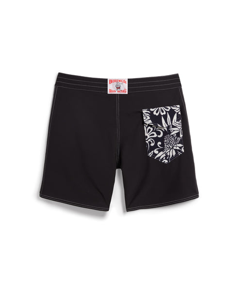 Birdie Boardshorts in black with side paneling with black and white floral pattern. Back pocket on right side with velcro closure. License Plate Label with Birdwell Logo on waistband.