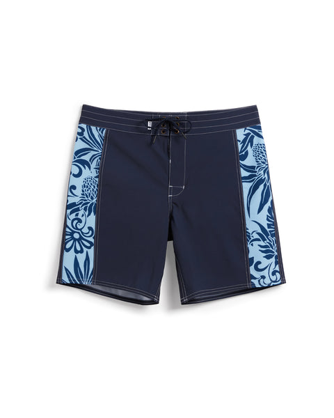 Birdie Boardshorts in navy with side paneling with dark blue and light blue floral pattern. Drawcord with brass grommets.