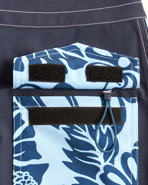 Back pocket with velcro closure and key loop featuring  dark blue and light blue floral pattern.