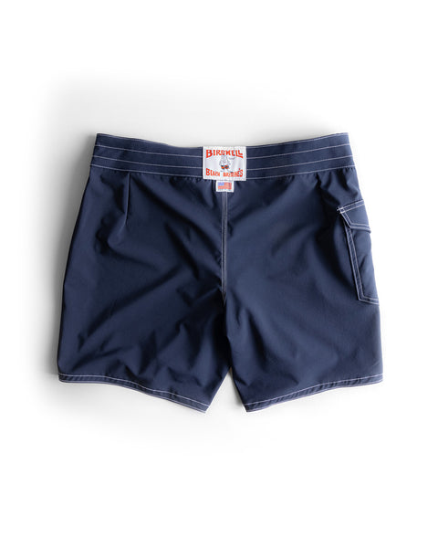 The 806 SurfStretch Side Pocket Boardshorts in navy feature white stitching, a right-side back pocket, and a red-and-white Birdwell label above the waistband. Shown flat on a white background.