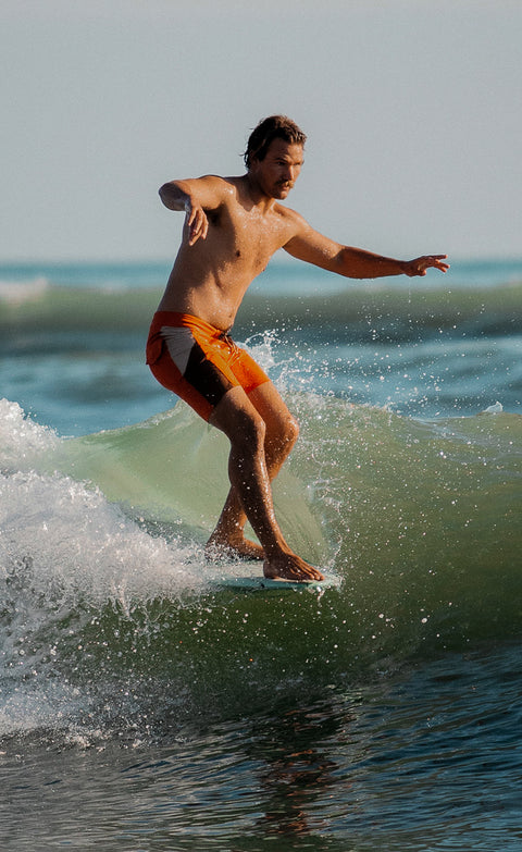 Kevin surfing while wearing the new birdie boardshort in paprika and tobacco.