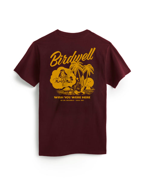 Back view of the Burgundy T-Shirt with Birdwell Wish You Were Here So Cal Originals Since 1961 Screenprinted on the back with Birdie Dreaming of a Hula Birdie. Product on white background.