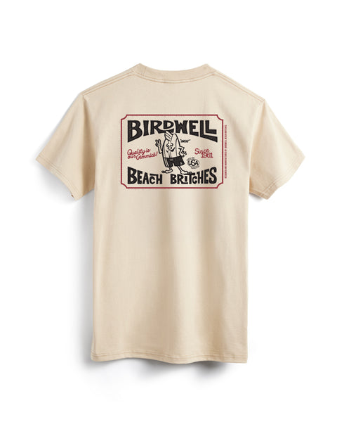 Back View of Hangtag T-Shirt in Sand. Graphic in Black and Red. Graphic depicts Birdie holding a peace sign. Surrounded by a ticket graphic. Product on white background.