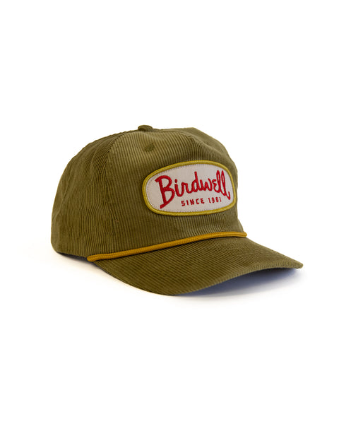 Green cap with a Birdwell logo on a white background