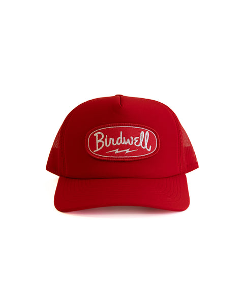 Red cap with 'Birdwell' oval patch logo on a white background