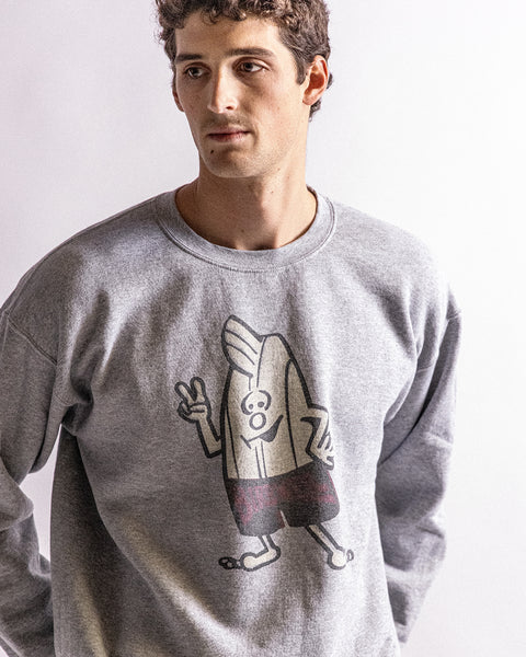 Man wearing a gray sweatshirt with a birdie on a plain background