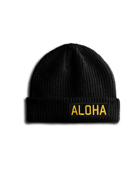 Black beanie with 'ALOHA' in yellow on a white background