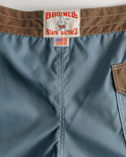Close up shot of the back of the boardshorts with license plate label and made in usa label.