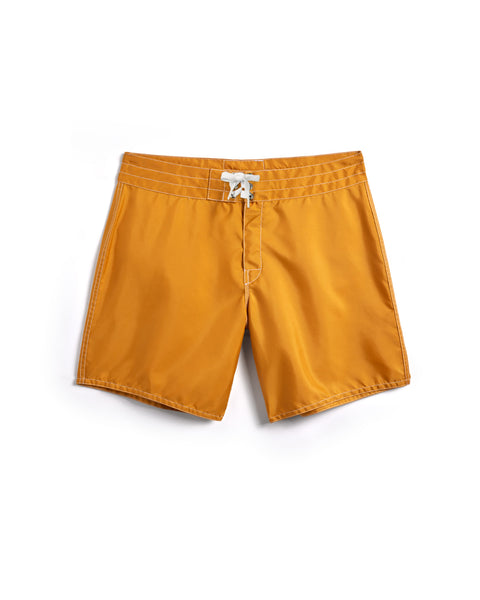 310 Boardshorts in gold over white background. White Drawcord and white contrast stitching.