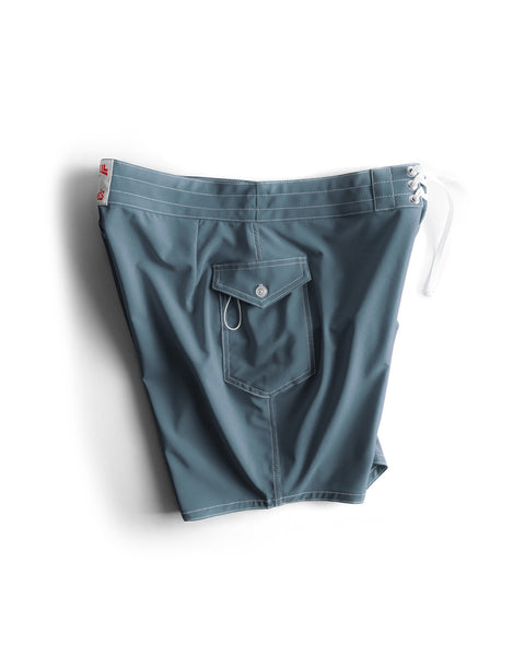 Side view of the 808 Boardshort in Federal Blue with white drawcord and white contrast stitching. Product on white background. Side view showing pocket.