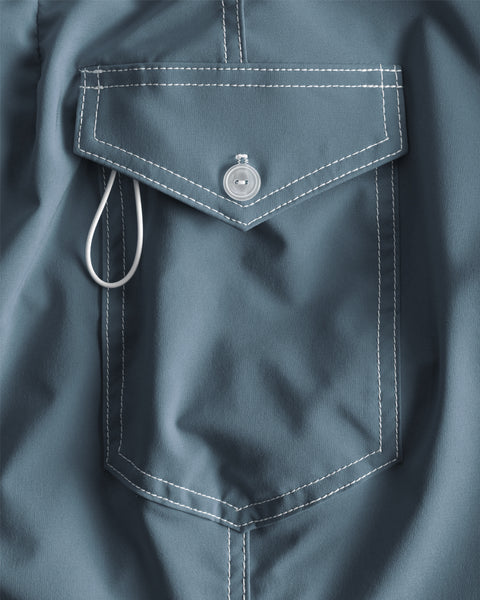 Close up of side pocket with federal blue fabric, white contrast stitching. White Keyloop and white button.