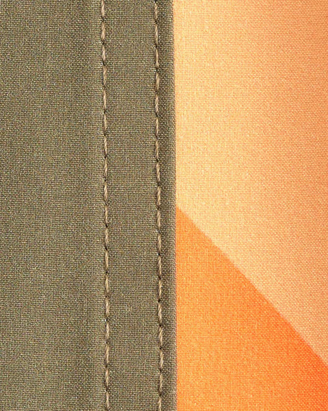 Detail shot showing close up of fabric. Left side army green, right side with sunset (yellow and orange)