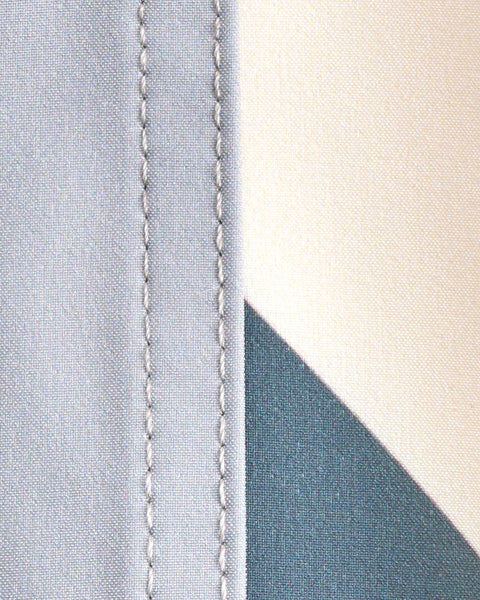 Close up fabric swatch. Left side showing quarry fabric, right side showing bone and slate panel.