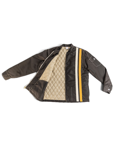 Birdwell Quilted Racing SurfNyl® jacket in brown with a cream/light brown quilted interior and a yellow and white vertical stripe on the exterior left side on a white background
