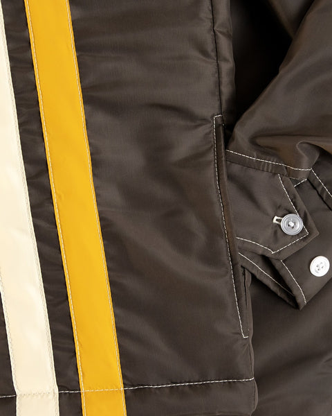 Close-up of the Birdwell Quilted Racing jacket exterior pocket with the sleeve slightly in the pocket. The sleeve cuff shows two button closures. 