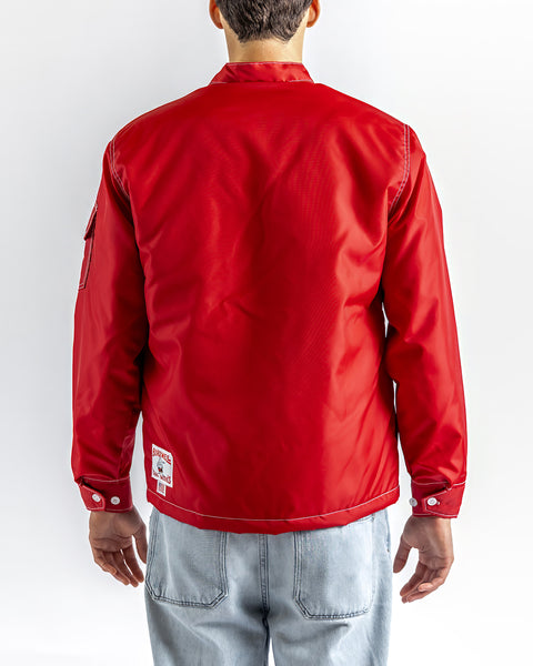 Model is wearing a red jacket with a Birdwell square classic logo on the back bottom left against a white background