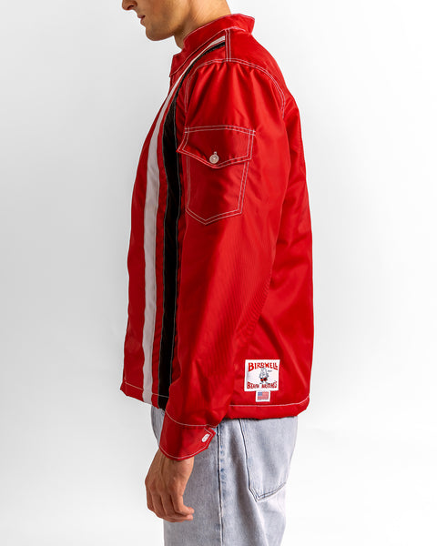 Model wearing the Birdwell Quilted Racing SurfNyl®  in red with a brand logo on the bottom left hem, with a button pocket closure on the left arm in front of a white background