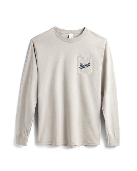 Beige long-sleeve shirt with a small logo on a white background