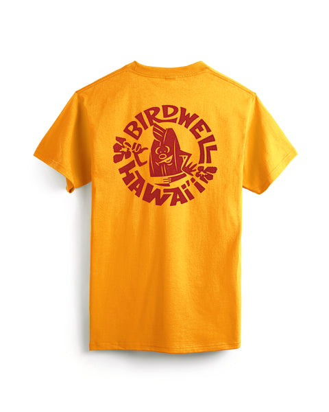 This image is the back of the Shaka short sleeve Pocket T-Shirt in Gold with a logo circle logo of Birdie with a shaka in red on the back center of the t-shirt against a white background
