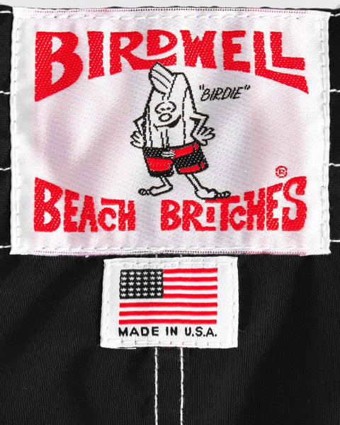Birdwell Beach Britches label on back with American flag on black boardshort