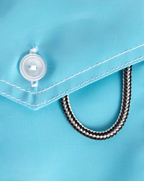 Close-up of the light Blue back pocket with a button and a metal chain detail.