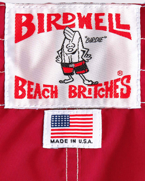 Birdwell Beach Britches label with the Birdie character and American flag on red fabric
