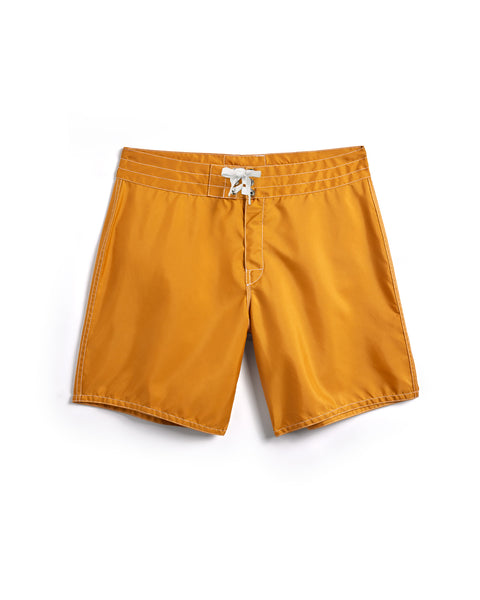 Mustard yellow shorts with a white drawstring on a white background