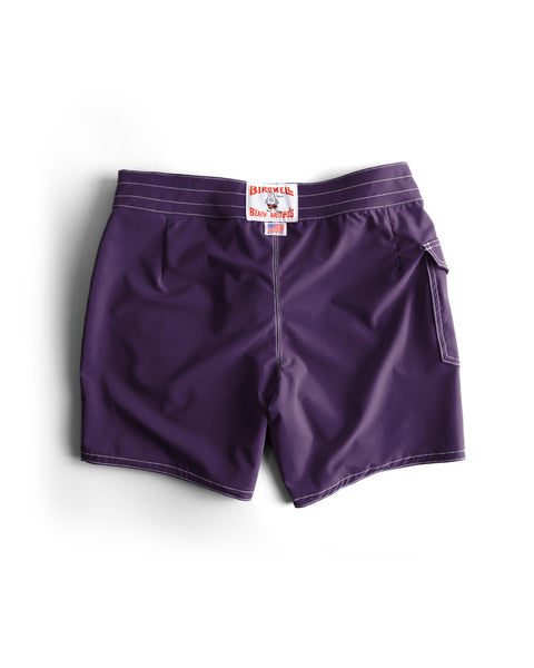 Purple shorts with a brand tag on a white background