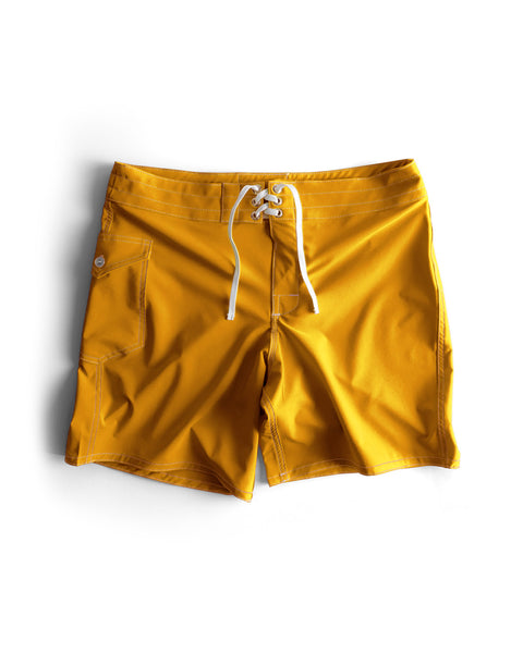 Yellow swim shorts with a white drawstring on a white background