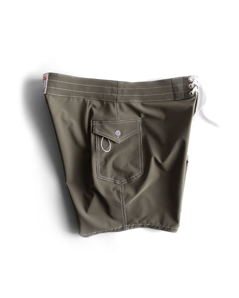 The 808 SurfStretch Side Pocket Boardshorts - Army feature olive green fabric with white stitching, a white lace-up waistband, side and back pockets with button flap/key loop, are medium-length, made in the USA, and shown laid flat on white.