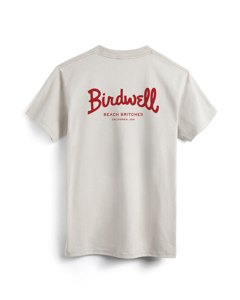 Beige t-shirt with red 'Birdwell' logo on a white background