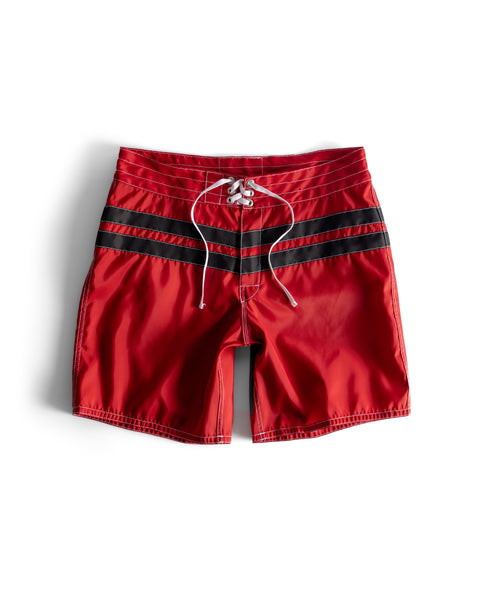 Red swim shorts with black stripes on a white background