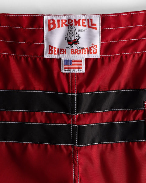 Close-up of a red and black striped garment with a Birdwell label.