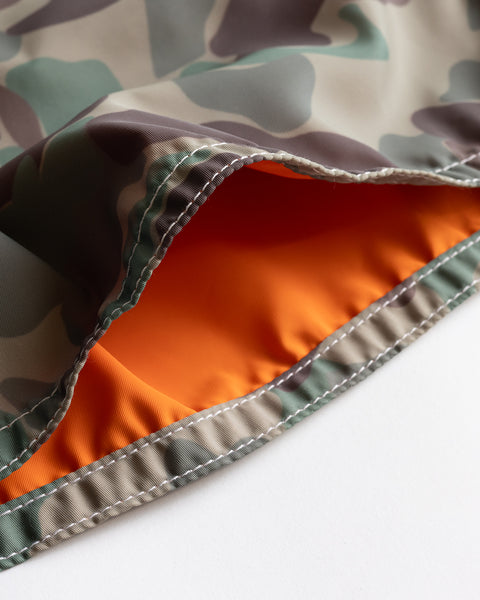 Close-up of 300 Boardshorts - Frogskin Camo, made in the USA with a camouflage exterior and bright orange lining, detailed stitching, and crafted from SurfNyl fabric inspired by classic boardshorts quality.
