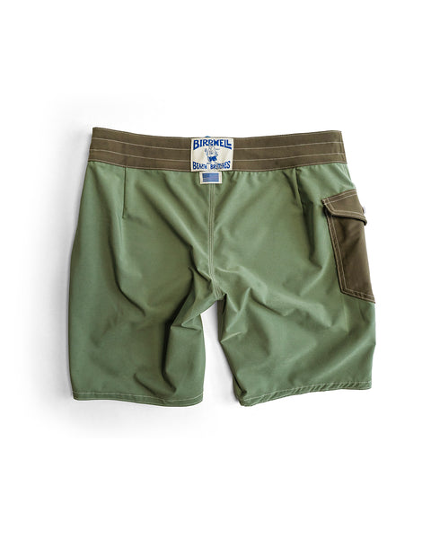 The 808 Powerbird - Olive features olive green SurfStretch board shorts with a brown waistband, side pocket, and white Birdwell logo patch. Made in the USA, these boardshorts are shown flat on a white background.
