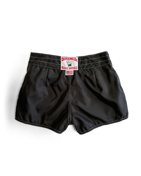 A pair of black 400 Boardshorts displayed flat on a white background, featuring white stitching and a bold red and white BIRDWELL / BEAMS BROTHERS label sewn onto the waistband for classic, quick-drying style.