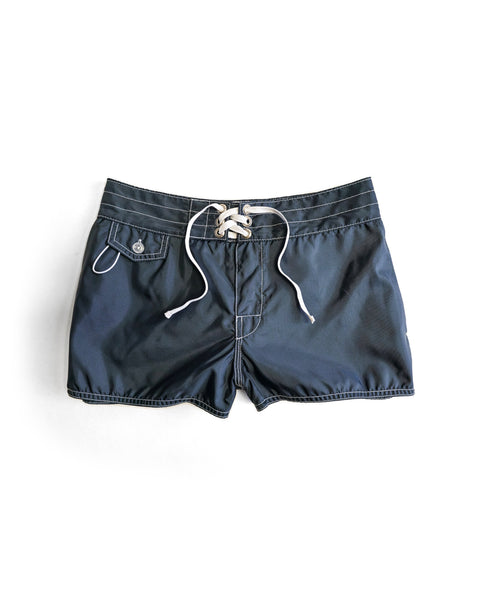 400 Boardshorts - Navy: Made in the USA, these navy SurfNyl boardshorts feature white stitching, a front lace-up drawstring, and a small buttoned pocket on the left side, shown laid flat on a white background.