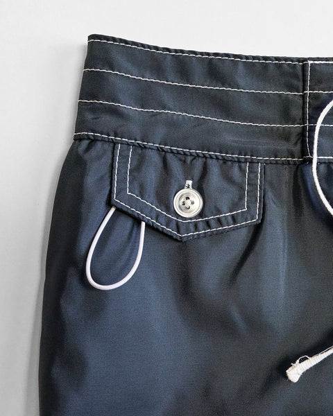 Close-up of the waistband and pocket of the 400 Boardshorts - Navy, featuring white contrast stitching, a buttoned flap pocket, and a partially visible white drawstring in classic SurfNyl boardshorts style.