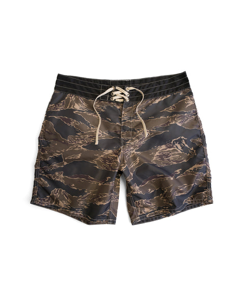 The 300 Boardshorts - Tiger Camo feature a black, brown, and tan camouflage pattern with a white drawstring waist. Made from durable SurfNyl fabric for long-lasting comfort and style.