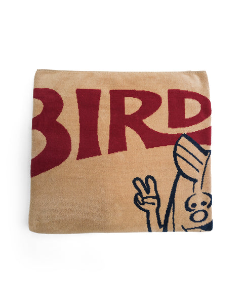 A folded over-sized License Plate Towel - Bone, crafted from 100% cotton, features large red letters spelling BIRD and a cartoon hand making a peace sign partially visible at the bottom right.