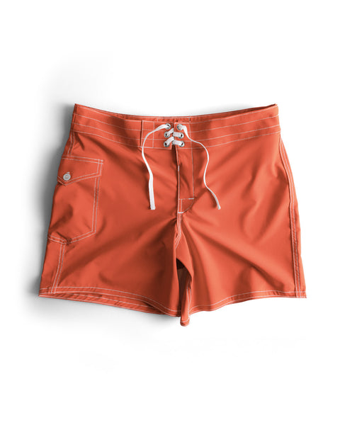 The 806 SurfStretch Side Pocket Boardshorts in Paprika feature white stitching, a lace-up front, and a side flap pocket with a button. Made in the USA from SurfStretch® fabric for superior comfort and flexibility, these trunks are shown laid flat on a white background.