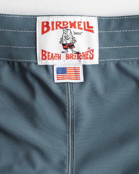 Federal Blue 806 SurfStretch Side Pocket Boardshorts featuring a Birdwell Beach Britches brand patch and a small American flag label below the waistband.