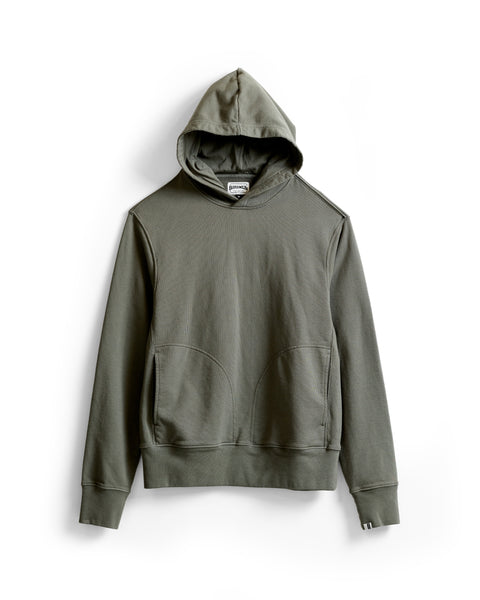 The Harmony Hoodie - Dark Olive is a premium olive green hoodie with long sleeves, front pockets, and ribbed cuffs, crafted from soft French terry and displayed flat on a white background.