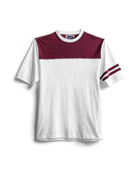 The Special Teez Champ - Vintage White/Burgundy is a premium short-sleeve t-shirt featuring a white base with a bold burgundy (maroon) panel across the chest and shoulders, as well as two matching stripes on the left sleeve. Made in the USA from 100% cotton, the shirt is displayed laid flat on a white background.