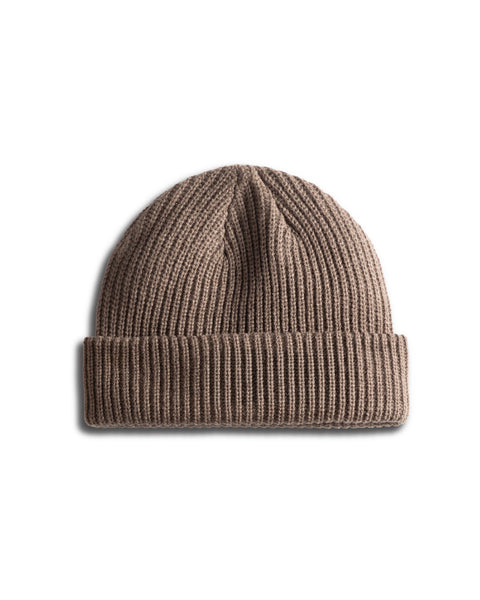 The Powerbird Watchcap in Walnut is a wide ribbed knit beanie hat with a folded brim in the classic fisherman style, shown against a white background.