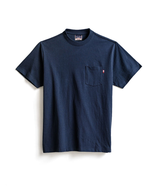 The High Tee Pocket - Navy is a short-sleeve t-shirt, crafted from 100% cotton, featuring a small chest pocket on the left side. The shirt is displayed laid flat on a white background.