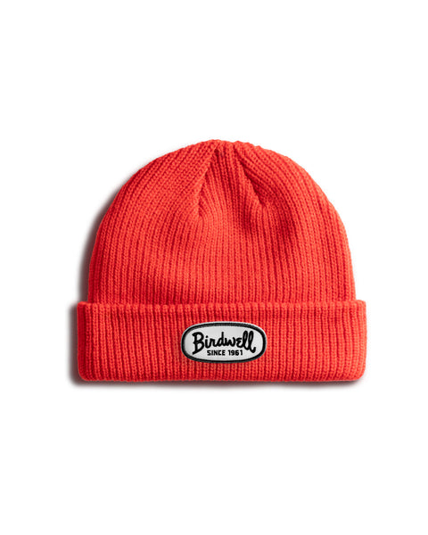 The Potato Watchcap - Red is a bright red, wide ribbed beanie with a folded brim and a black and white Birdwell Since 1961 patch on the front. The beanie is displayed on a white background.