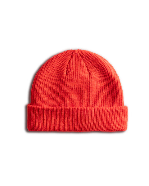 A Potato Watchcap - Red, featuring a ribbed design and folded brim, is displayed against a white background.