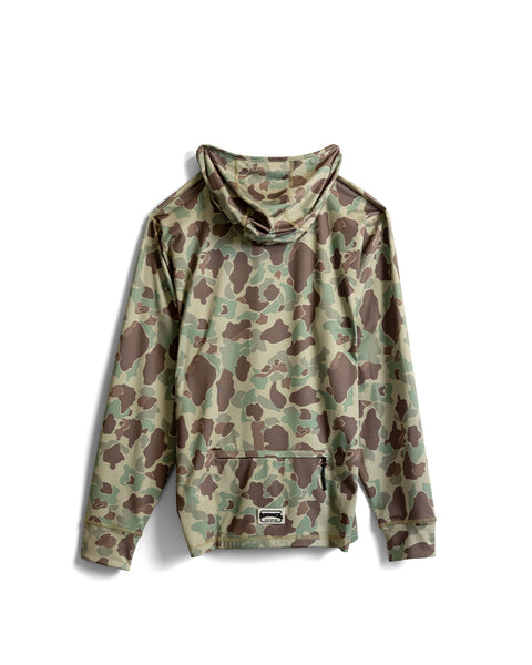 A Sunteez Hoodie - Frogskin Camo is laid flat with the back facing up, featuring a green, brown, and tan camouflage pattern that covers the entire long-sleeve hooded jacket. Designed as a moisture-wicking layer for active days outdoors, it also includes a zippered pocket near the bottom.