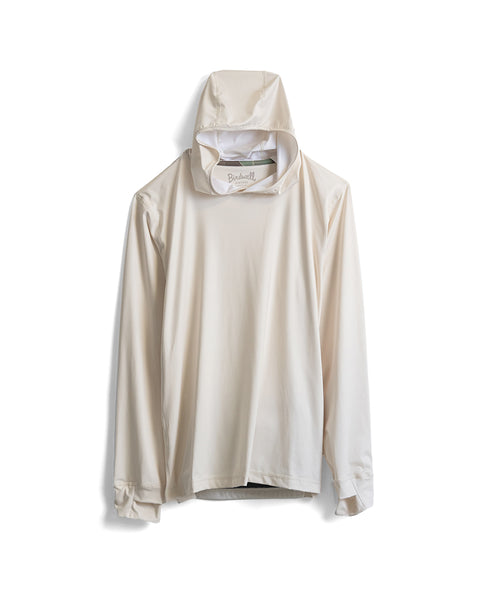A Sunteez Hoodie in Bone, a long-sleeve off-white hooded shirt made in the USA, hangs on a hook against a white background, with a visible neck tag that reads Birdwell.